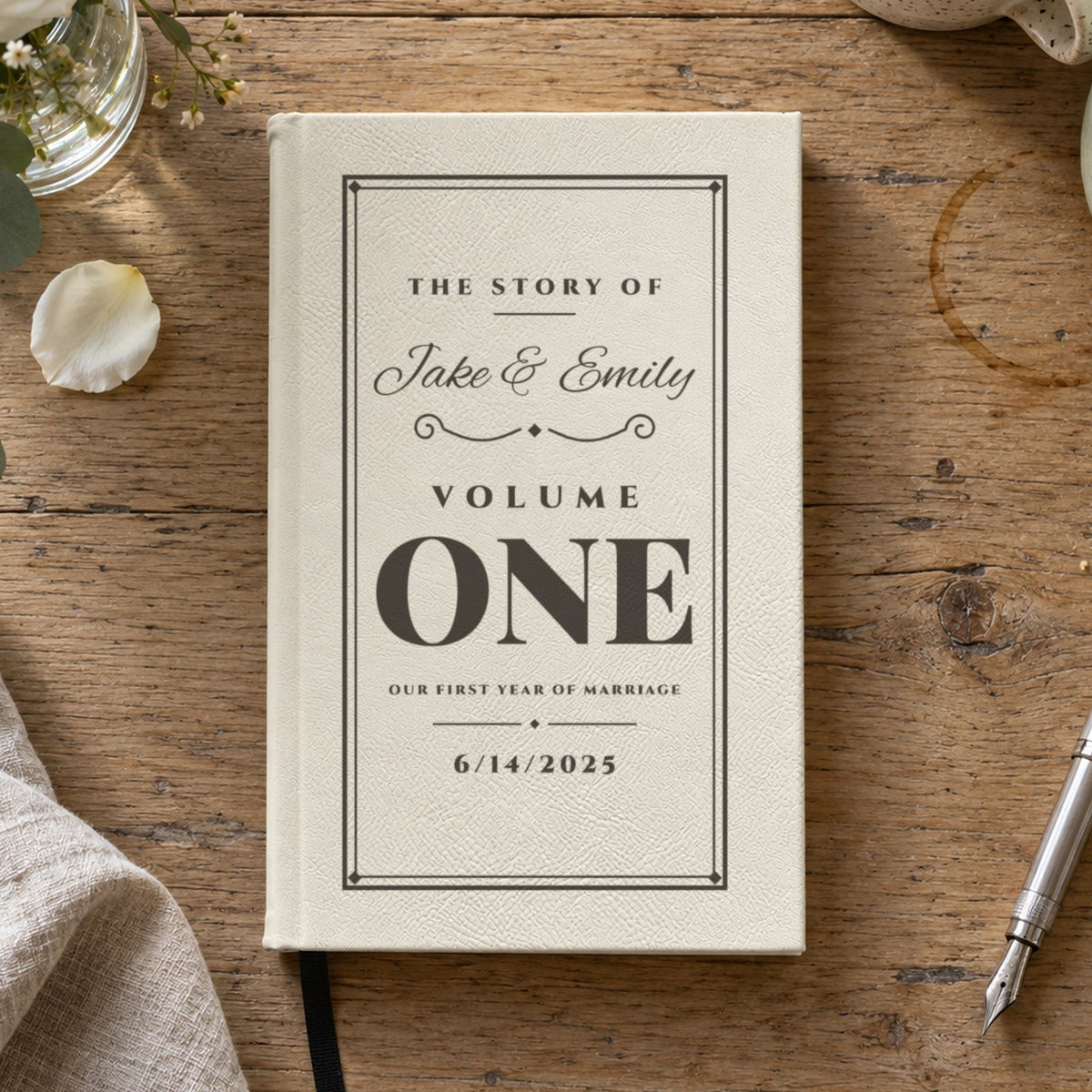 First anniversary journal in white engraved with The Story Of Jake &amp; Emily, Volume One and the wedding date, a personalized paper anniversary gift