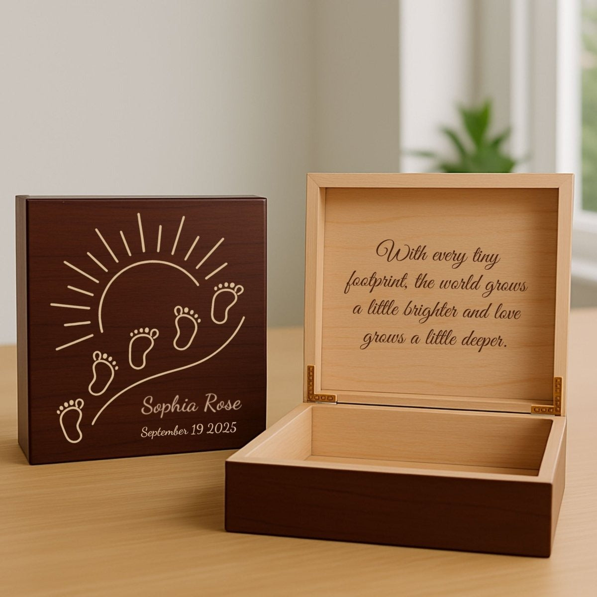 Cherry newborn keepsake box engraved with baby footprints, a sunrise and the sample name Sophia Rose, shown beside the open box with a message inside the lid