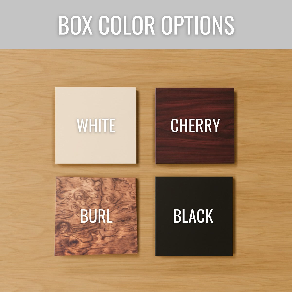 Four finish options for the personalized newborn keepsake box shown as square swatches on a wood table: white, cherry, burl and black