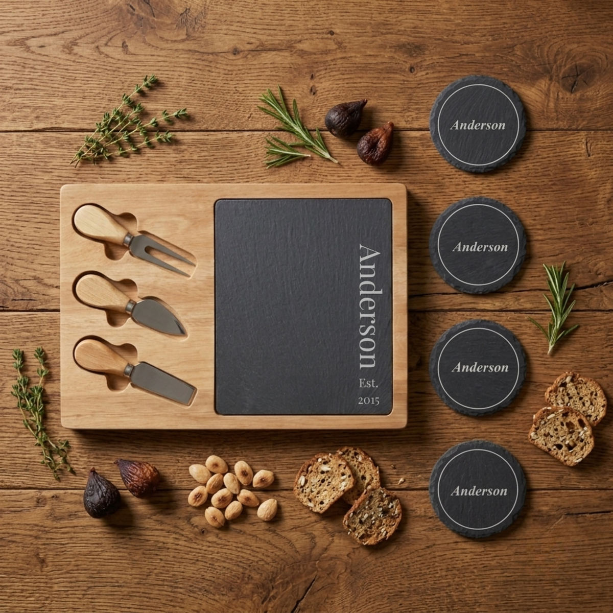 Personalized slate cheese board and coaster set engraved with the last name Anderson and Est. 2015, styled with three wood-handled cheese knives