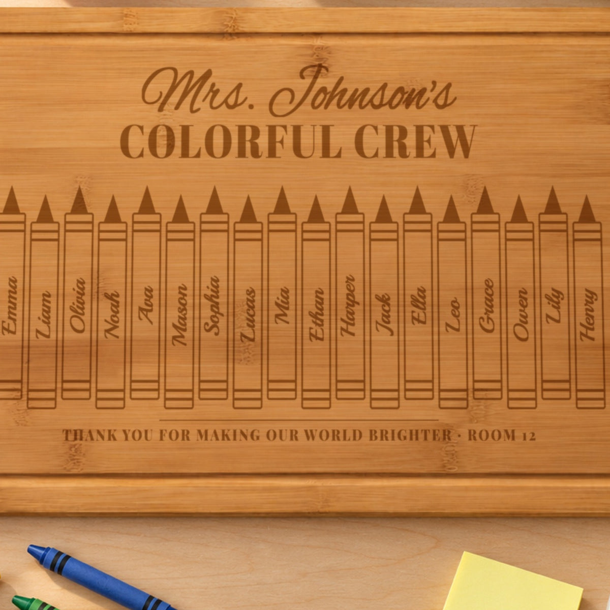 Close-up of the laser engraving on the teacher crayon board: Mrs. Johnson's COLORFUL CREW and student names written down each crayon